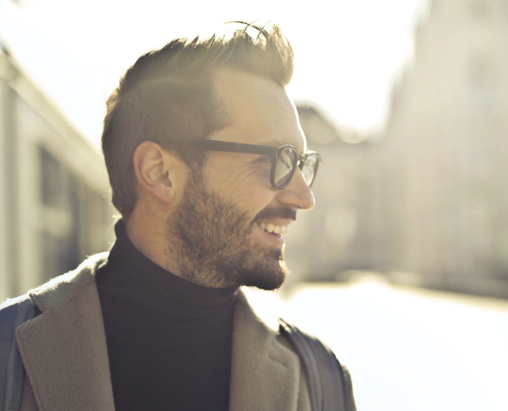 Patient smiling outdoors showing improved dental confidence